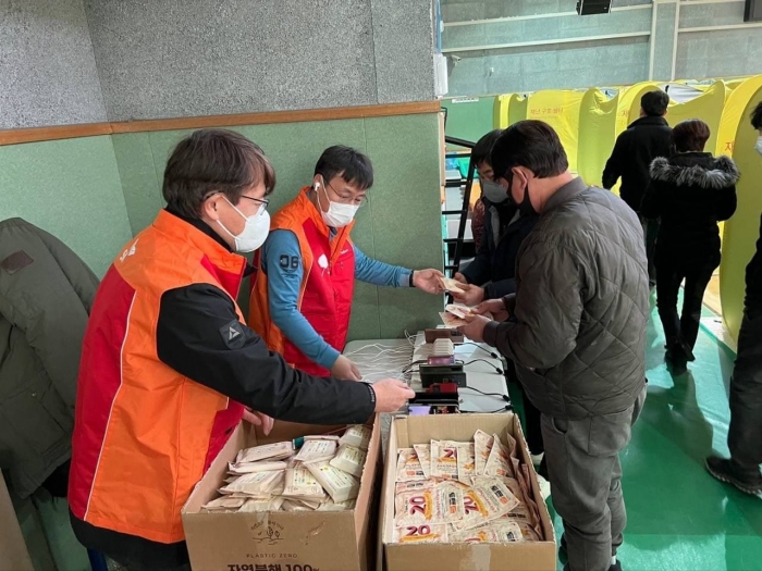 SK텔레콤 구성원들이 지난 5일 경북 울진 국민체육센터에 설치된 대피소에서 주민들에게 핫팩 등 생필품을 지원하고 있다.